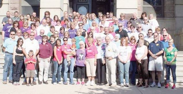 Nancy Hickey's co-workers, friends and family gather around her on the steps of the Ionia County Courthouse, where she worked, for the "Stomp Out Nancy's Cancer Walk" in September 2011. Hickey died Nov. 24, 2012.