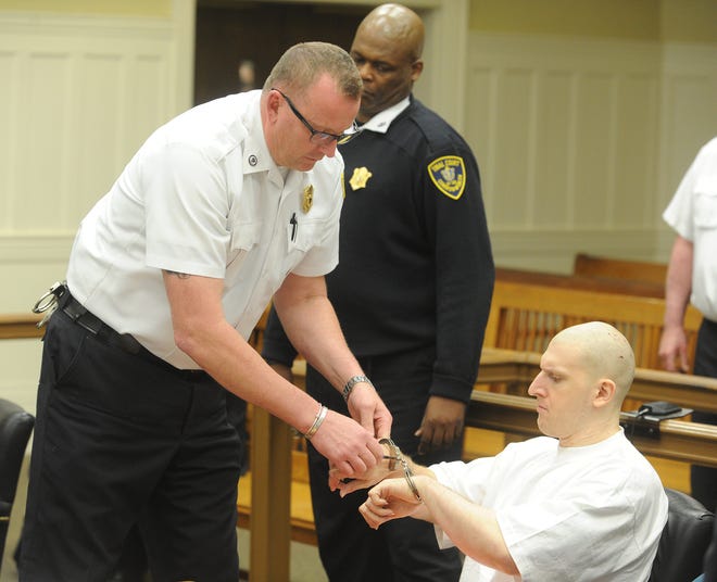 Keith Luke, of Brockton, is handcuffed for a court recess as a jury is in impaneled for his murder trial on Tuesday, May 14, 2013 at Plymouth County Superior Court.