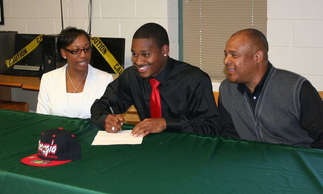 Flanked by his parents, Valeria and Lloyd Harden, Greenbrier sprinter Jeremy Harden signs his letter of intent to run track for the University of Georgia.
