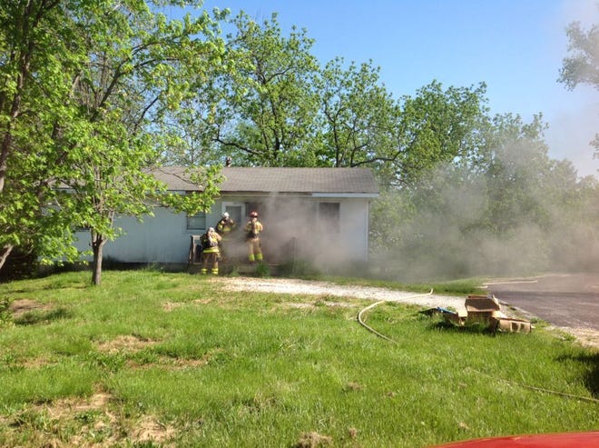 Columbia firefighters battle a blaze at a vacant home in northeast Columbia on Tuesday. Police are aiding in the investigation because witnesses reported seeing activity around the house before the fire.