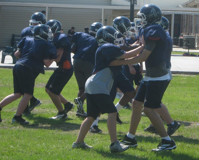 Houma Christian offensive and defensive linemen work on blocking drills at a recent spring football practice in Houma.