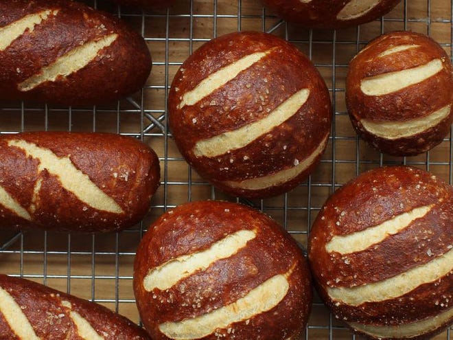 While the innards of a sandwich naturally get the most attention, stacking them inside a strikingly contrasted pretzel bun doubles the pleasure.