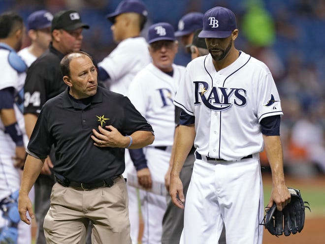 Tampa Bay trainer Ron Porterfield, left, looks at starting pitcher David Price, right, as he leaves the game with an injury during the third inning against the Boston Red Sox.
(CHRIS O'MEARA | THE ASSOCIATED PRESS)