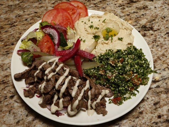 Habibi serves its Beef Shawarma Platter with hummus, tabouli and fatoush salad.