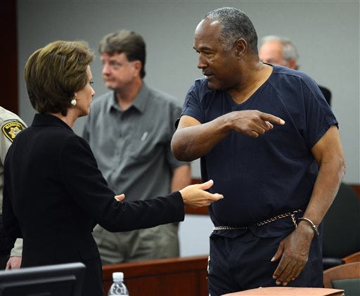 O.J. Simpson, right, talks to his defense attorney Patricia Palm during a break in the second day of an evidentiary hearing in Clark County District Court, Tuesday, May 14, 2013 in Las Vegas.