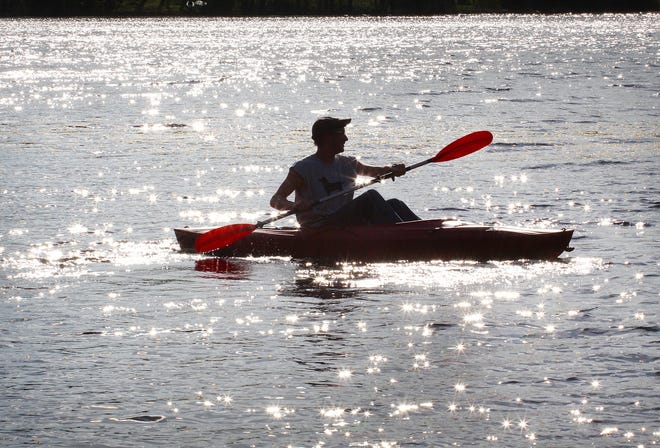 Paul Dubrawski of Abington paddles his kayak at Jacobs Pond in Norwell.