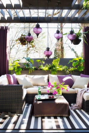 BRIAN PATRICK FLYNN | HAYNEEDLE.COM | ASSOCIATED PRESS
A narrow 14-foot by 9-foot outdoor space was turned into a full-fledged living room
by designer Brian Patrick Flynn in his own home, by adding a pergola for shade and
suspending outdoor pendant lights, privatizing the area from neighbors with a planter wall, using a U-shaped sectional for seating up to seven, and creating an indoor feeling with a braided indoor-outdoor area rug.