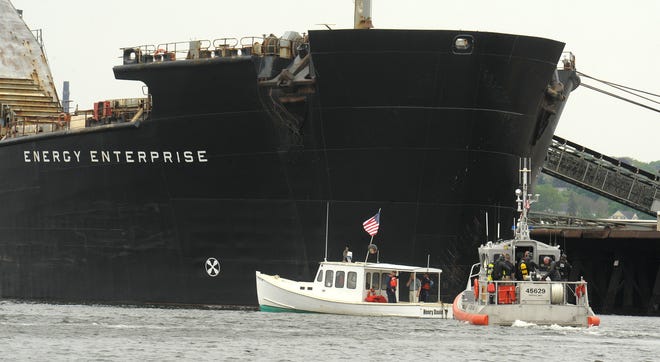 A standoff between the enormous coal ship Energy Enterprise and the 30-foot downeaster Henry David T. , representing an environmental group, continues hours after it started as U.S. Coast Guard divers prepare to enter the water Wednesday afternoon.