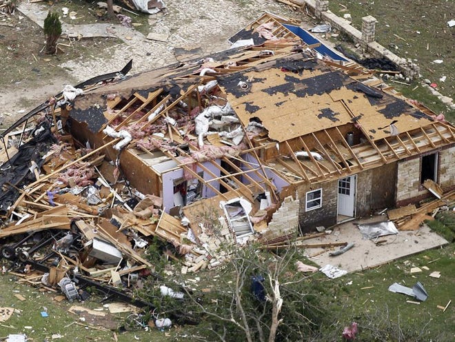 An aerial view shows a heavily damaged home in Granbury, Texas, on Thursday. Ten tornadoes touched down in several small communities in North Texas overnight, leaving at least six people dead, dozens injured and hundreds homeless. 
(Ron T. Ennis | The Fort Worth Star-Telegram)
