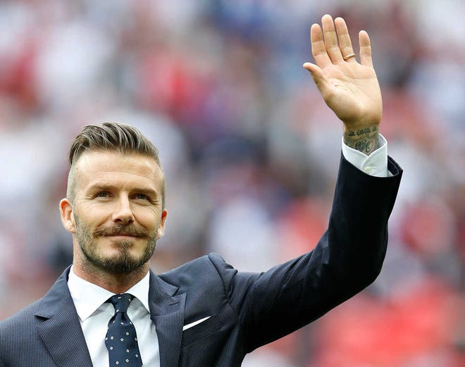 David Beckham gestures during a ceremony to honor the five players that have played for England over 100 times each during the international friendly soccer match between England and Belgium at Wembley Stadium in London on June 2, 2012.