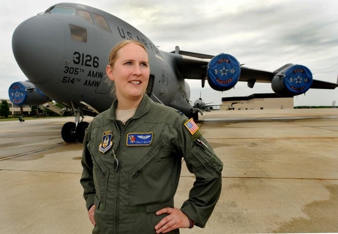 Thirty one year old Air Force Reserve Captain Holly Nelson, a C17 pilot, stands on the flightline at Joint Base McGuire-Dix-Lakehurst in front of the plane she flies. She was recently named by the USO with the Military Leadership Award. She was also selected as the Air Force Reserve Command representative in the Airlift Tanker Association's Young Leadership Award competition.