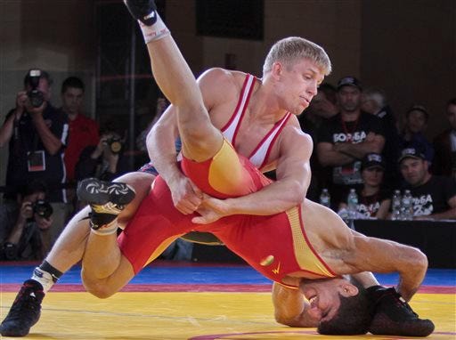 United States freestyle wrestler Kyle Dake, top, takes down Iran's Hassan Tahmasebi during competition at an international wrestling competition at Grand Central Terminal, Wednesday, May 15, 2013, in New York. The U.S., Iran and Russia will compete in a "solidarity" event billed "The Rumble On The Rails" to showcase competition as part of World Wrestling Month.