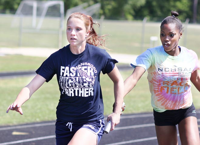 Swansboro's Alex Blue takes a handoff from Ashton Champion as they practiced a relay this week in preparation for Friday's NCHSAA 2-A state track and field championships.