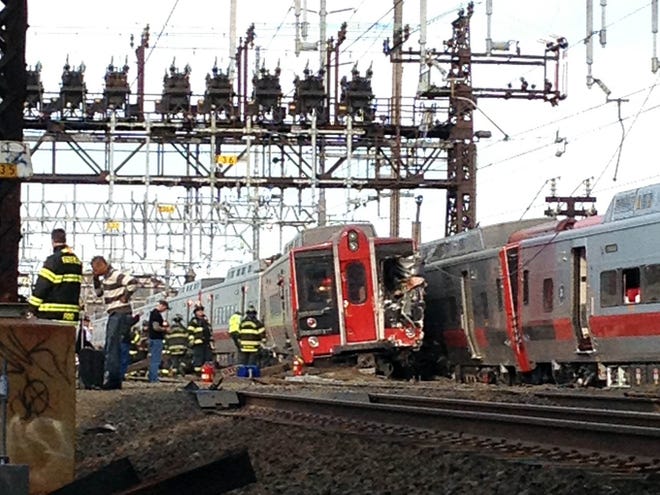 Emergency workers arrive the scene of a train collision, Friday in Fairfield, Conn. A New York-area commuter railroad says two trains have collided in Connecticut. The railroad says the accident involved a New York-bound train leaving New Haven. It derailed and hit a westbound train near Fairfield, Conn. Some cars on the second train also derailed. (AP Photo/The Connecticut Post, Christian Abraham)