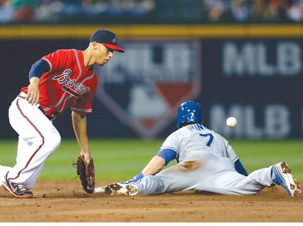 L.A. Dodgers’ Nick Punto steals second base as the ball gets away from Atlanta’s Andrelton Simmons on Friday. (John Bazemore | Associated Press)