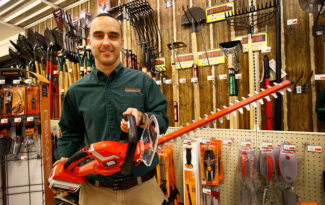 Aubuchon Hardware, Cohasset, manager Shane Thomas holds up a corless Black and Decker hedge trimmer.The 36 volt trimmer has a 24 inch cutting bar and retails for $159.99. Tuesday May 14, 2013.