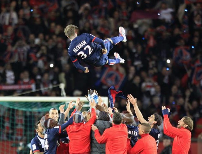 Paris Saint Germain's midfielder David Beckham from England, is thrown in the air by his teammate at the end of their French League One soccer match against Brest, at the Parc des Princes stadium, in Paris, Saturday, May 18, 2013. Paris Saint-Germain hopes to strike a deal with David Beckham in the next two weeks in which the former England captain will work with the French club after retirement, possibly in an ambassadorial role.