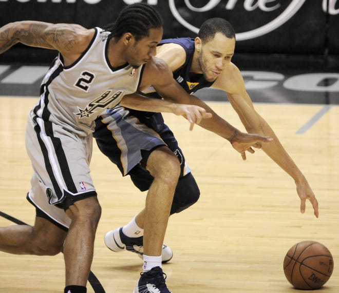 Memphis Grizzlies' Tayshaun Prince (right) and San Antonio Spurs' Kawhi Leonard chase a loose ball during the second half of Game 1 of the Western Conference final NBA basketball playoff series, Sunday in San Antonio. (AP Photo/Darren Abate)