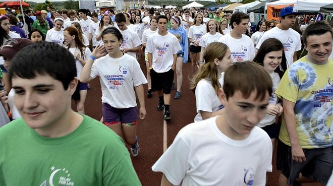 Hundreds walk along the track at Tohickon Middle School Saturday for this year’s Relay for Life. It was the 10th anniversary of the Central Bucks relay that raises funds to combat cancer.