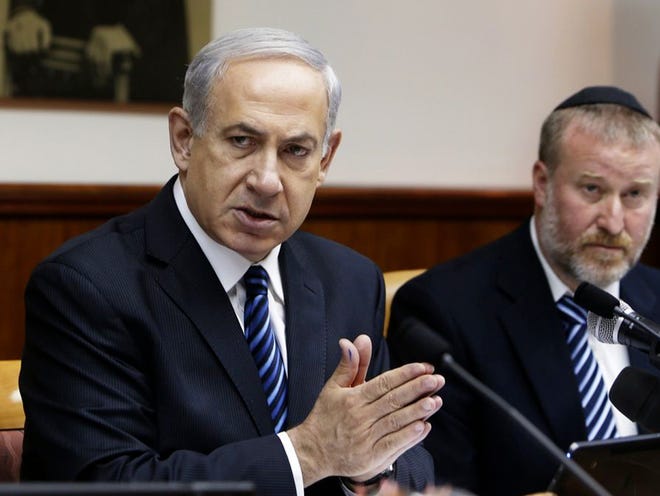 Israel's Prime Minister Benjamin Netanyahu, left, speaks as he sits next to Cabinet Secretary Avichai Mandelblit during a weekly cabinet meeting in Jerusalem, Israel, on Sunday.
(RONEN ZVULUN | THE ASSOCIATED PRESS)