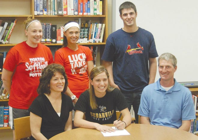 Morton High School senior Nikki Eigsti, middle, signed May 8 with Cedarville University, where she will play softball for the Yellow Jackets. With Eigsti in the MHS library were, in front, from left: her parents, Pam and Mark Eigsti; second row: MHS softball assistant coach Megan Hasler, MHS softball head coach Stacey Buescher and Eigsti's brother, Nathan Eigsti.