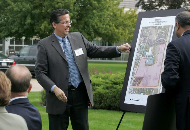 Thomas Gendron, Woodward chairman and CEO, unveils a map of the new 60-acre Woodward Rock Cut Campus during the announcement Thursday, Aug. 23, 2012, that the facility will be built in Loves Park.