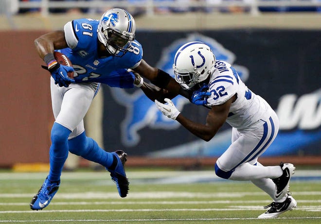 Detroits' Calvin Johnson (left), a former Georgia Tech standout, said he "had a couple of injuries" to his fingers during a record-breaking year last season.