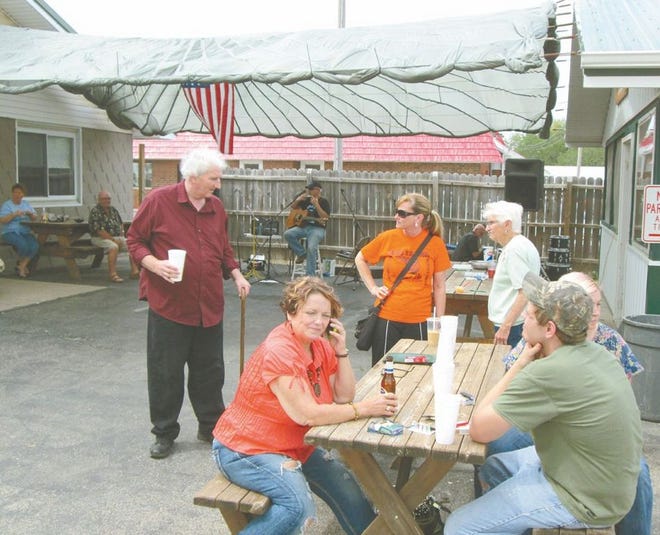 Stacey Creasey, editor of the Fulton Democrat (dark red shirt), visits with some of the people attending a benefit Saturday to raise funds for medical expenses. Creasey was seriously injured in a car accident in December and is hoping to come back to work full-time at the end of this month.