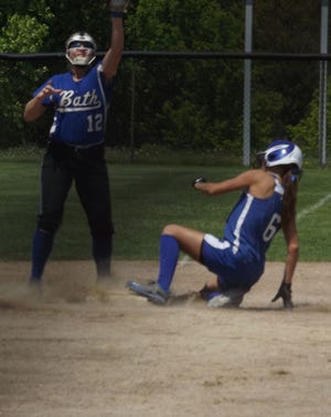 Ionia junior Taylor Bovee slides into third ahead of the throw Saturday afternoon during the Bulldogs’ game against Bath at the Ionia Invitational.