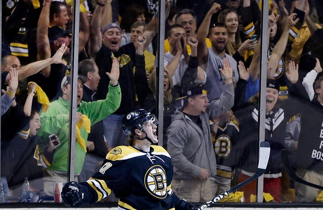 Fans cheer as Bruins defenseman Torey Krug celebrates after scoring during the first period of Boston's 5-2 win over the Rangers on Sunday.