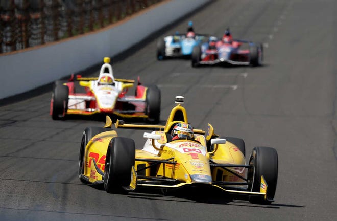 Ryan Hunter-Reay leads Helio Castroneves into the first turn Sunday during a practice session on the second day of qualifications for the Indianapolis 500.