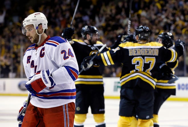 New York Rangers right wing Ryan Callahan (24) skates away as the Boston Bruins celebrate a goal during the second period in Game 2 of the NHL Eastern Conference semifinal hockey playoff series in Boston, Sunday, May 19, 2013. The Bruins won 5-2.