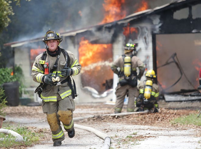 The Panama City Fire Department works the scene of a garage fire on Palmetto Avenue in Panama City, Fla. on Monday, May 20, 2013.