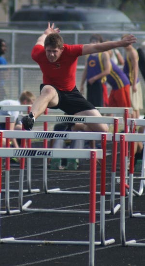 Sam Ryan jumps the hurdles at the Macomb Sectional Thursday.