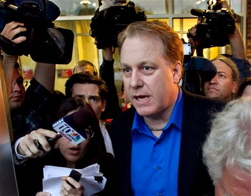 FILE - In this May 21, 2012 file photo, former Boston Red Sox pitcher Curt Schilling is followed by members of the media as he departs the Rhode Island Economic Development Corporation headquarters in Providence, R.I. A lawyer for Schilling and executives of his now-bankrupt video game company argued Wednesday, May 22, 2013 in Superior Court in Providence that a lawsuit against them should be dismissed because they disclosed everything to the state's economic development agency before being granted a $75 million loan guarantee.