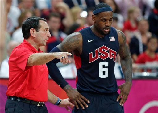 FILE- In this Aug. 4, 2012, file photo, United States coach Mike Krzyzewski talks with LeBron James during a men's basketball game against Lithuania at the 2012 Summer Olympics in London. A person with knowledge of the decision says Krzyzewski has agreed to return as U.S. men's Olympic basketball coach. He was originally expected to step down but instead will attempt to lead the Americans to a third straight gold medal, the person tells The Associated Press on condition of anonymity because no official announcement has been made. (AP Photo/Charles Krupa, File)