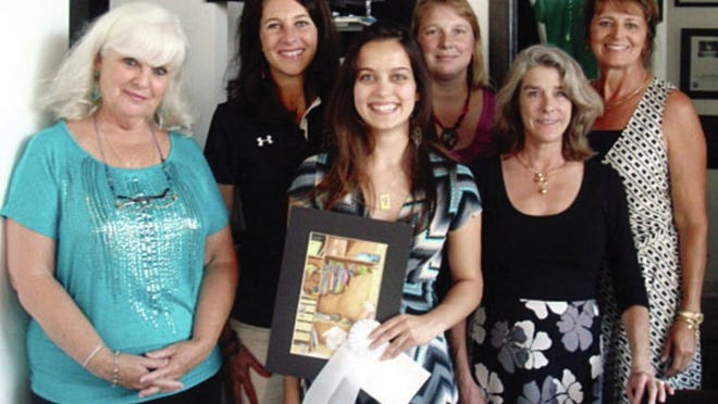 Lake Travis High School senior Ava Mallett, center, receives an arts scholarship last week from the Waterloo Watercolor Group at a reception for the LTHS arts program. She is joined by, from left, juror Rae Andrews, LTHS principal Kimberly Brents, LTHS art teacher Amber Kyle Forgey, Blue Days Studio owner Janet Sopp-Sims WWG president and Donna Overly.
