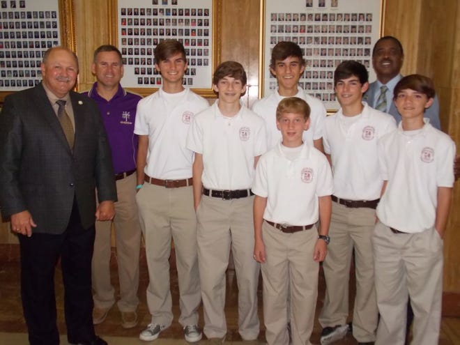 ACHS’ boys cross country team stand with Louisiana State Representatives John Berthelot and Ed Price at the State Capital last Thursday.