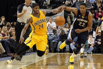 Dec 31 2012; Indianapolis, IN, USA; Indiana Pacers forward Paul George (24) chases after a loose with Memphis Grizzlies forward Rudy Gay (22) at Bankers Life Fieldhouse. Indiana defeats Memphis 88-83. Mandatory Credit: Brian Spurlock-USA TODAY Sports