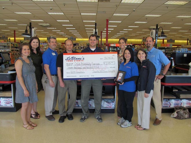 LeBlanc's Food Stores Associates present a check to the Child Advocacy Services Staff for child abuse prevention awareness, May 15.