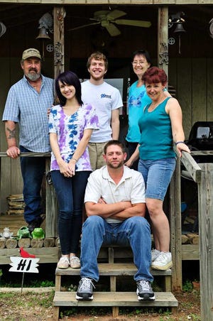 Jamie Menard (seated) is photographed with his wife, Heather (right); daughter, Shelby; her boyfriend, Chad Reynolds; and parents-in-law Joe and Ellie Hessek at their home in Waynesboro.