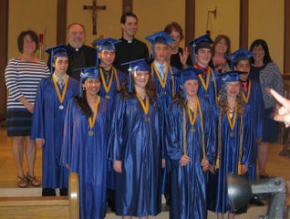 New Immaculate Conception School graduates pose for a photo at Thursday’s ceremony.
