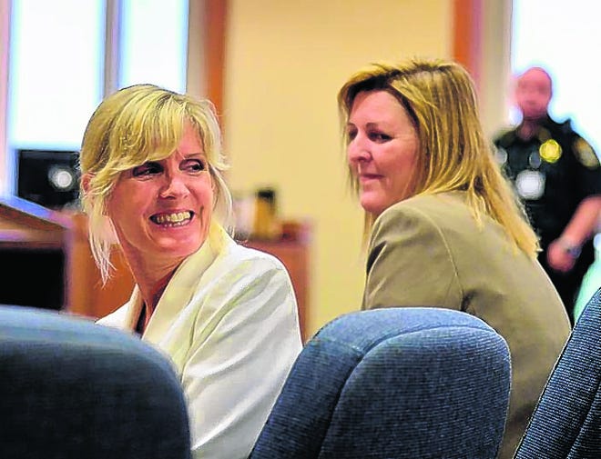 Sally Adams, left, smiles at her family after a jury returned a not-guilty 
verdict on Friday. Adams had been charged with escape. Defense lawyer Andrea 
Mogensen is on the right. STAFF PHOTO / MIKE LANG