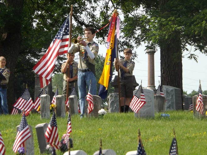 Boy Scout Gary McIntosh, 13, plays "Taps" on a bugle during a ceremony Saturday morning to honor the veterans of the Civil War buried in Topeka Cemetery.
