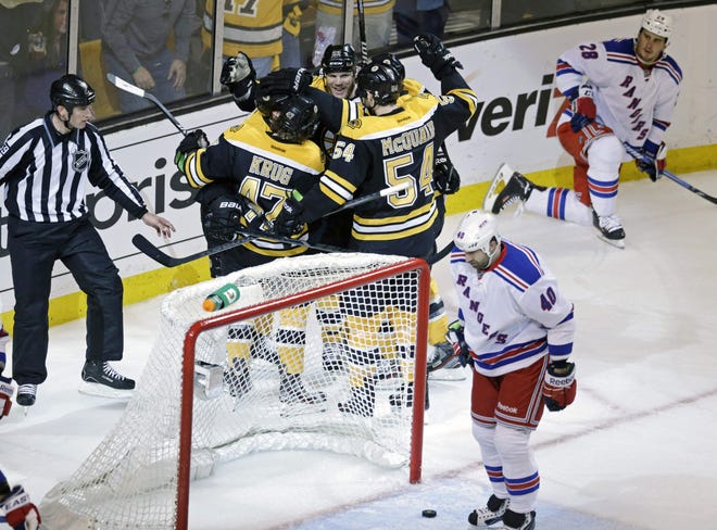 Boston's Gregory Campbell, top center, is surrounded by teammates after scoring the winning goal in the second period.