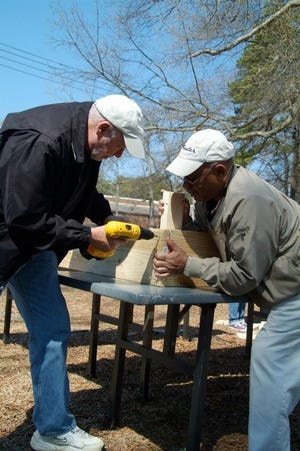 Celo Faucette helps build wooden planting boxes for North Park's community garden in March.
