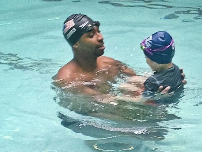Olympian Cullen Jones gives swimming lessons at Harlem's P.S. 125 in New York. About 70 percent of black children can't swim. 
(SIMONE SMALLS | THE ASSOCIATED PRESS)