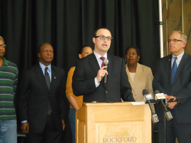 Rockford Mayor Larry Morrissey introduces Illinois Secretary of State Jesse White (left) at a news conference in Rockford Wednesday to announce the opening of a new driver services facility on the city’s west side. The state closed a long-standing west side office in July.