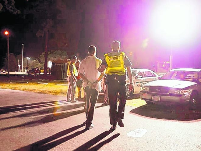 Sheriff's deputies arrest a driver at a DUI checkpoint in south Sarasota 
County on New Year's Eve, 2011. The National Transportation Safety Board has 
recommended that the blood-alcohol threshold for impairment for an adult 
driver be lowered from .08 to .05.HERALD-TRIBUNE ARCHIVE