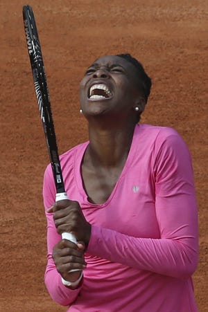 Venus Williams of the U.S. grimaces after missing a return against Poland’s Urszula Radwanska in their first-round match of the French Open tennis tournament, at Roland Garros Stadium in Paris on Sunday.